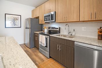 a kitchen with wooden cabinets and stainless steel appliances